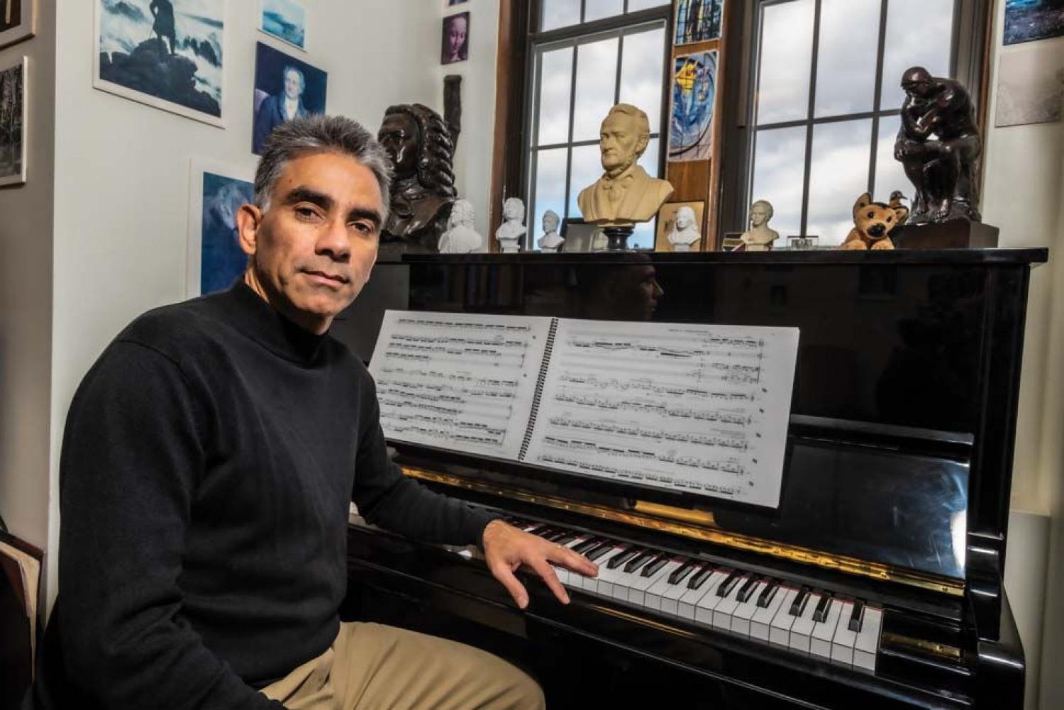 Ralf Gawlick seated at the piano in his office